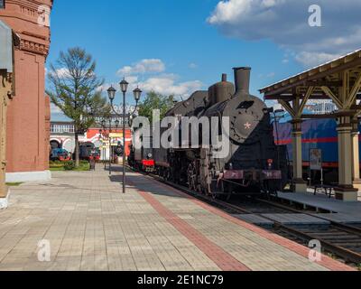 Old steam locomotive at the railway station Stock Photo