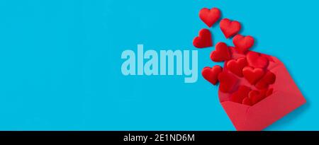 Hearts coming out of an red envelope on blue background Stock Photo