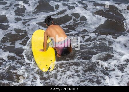 Surfer with yellow surfboard. Stock Photo