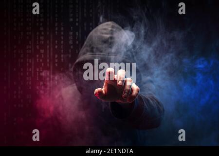 The dark web hooded hacker, digital binary code on background Stock Photo