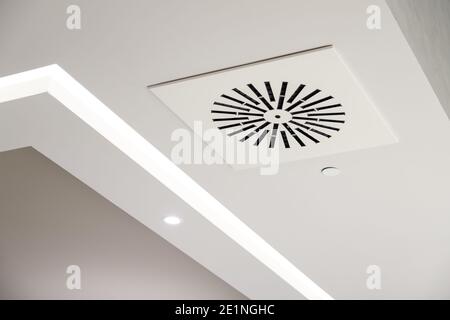 Circular air ventilation grill on the white ceiling Stock Photo