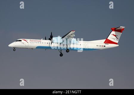 Tyrolean Airways Bombardier Dash 8 Q400 with registration OE-LGA in Austrian Airlines Livery on short final for runway 25L of Frankfurt Airport. Stock Photo
