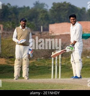 New Delhi India – July 01 2018 : Full length of cricketer playing on field during sunny day in local playground, Cricketer on the field in action, Pla Stock Photo
