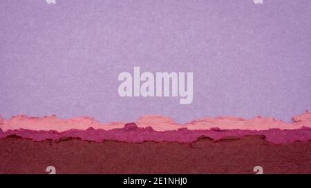 abstract landscape in pink and purple pastel tones created from sheets of handmade textured paper Stock Photo