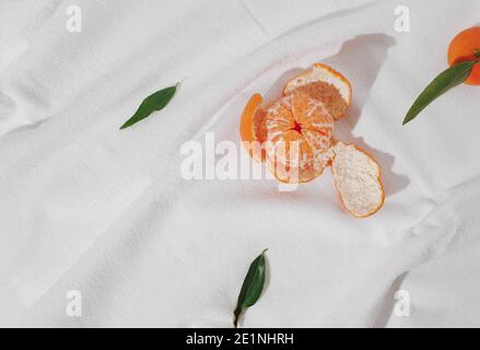 Creative background made with fresh tangerines on white  background. Minimal summer fruit flat lay. Stock Photo