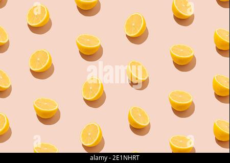 Creative pattern made with fresh lemon slices  on the beige pastel background. Minimal summer fruit concept. Stock Photo