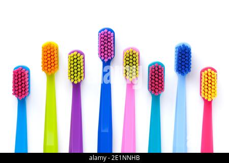 Set of multicolored toothbrushes isolated over white background. Flat lay. Top view Stock Photo