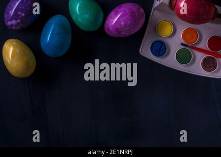 Easter multicolored eggs from stones on a dark background. Stock Photo