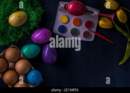 Easter multicolored eggs from stones on a dark background. Stock Photo