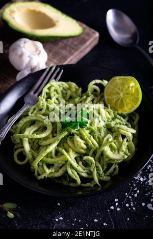 Zucchini raw vegan pasta with avocado dip sauce. Zucchini raw vegan pasta with avocado dip suace. Stock Photo