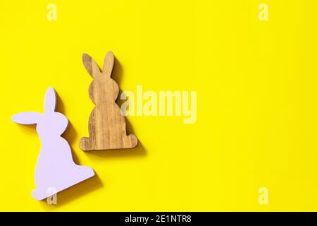 Creative minimal Happy Easter design the rabbits on Illuminating Yellow Color of the year 2021. Top view flat lay background. Copy space. Stock Photo