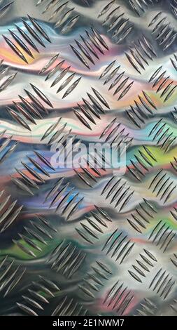 metal panel with notch and colored reflections stainless steel sheet with diamond plate pattern Stock Photo