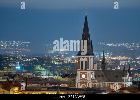 City Skyline at dusk of Town Jonkoping near big lake Vattern with Sofia Church in the middle of residential area in city center. Stock Photo