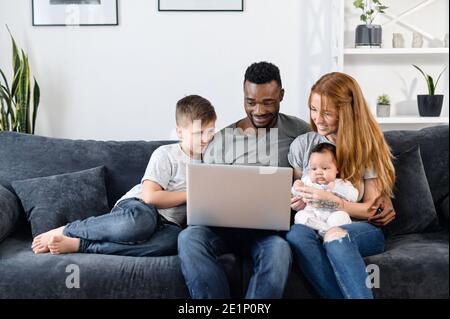 A multiracial family on the couch at home Stock Photo