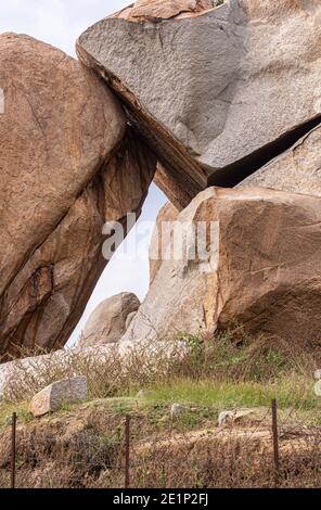 Hampi, Karnataka, India - November 5, 2013: Sister Stones group of brown stone boulders. Detail of gap between. Stock Photo