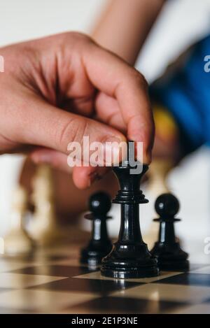 Hand of young player moving chess figure in competition. Success, strategy,  leadership concept Stock Photo