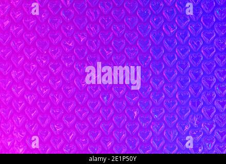 Blue and magenta  plastic bubble wrap with hearts created with filtered light. Can be used with various love and valentines day concepts. Abstract bac Stock Photo