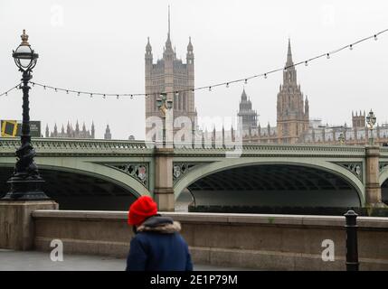 London, Britain. 8th Jan, 2021. A man walks by the River Thames in London, Britain, Jan. 8, 2021. Britain recorded another 68,053 coronavirus cases, the highest ever daily increase since the pandemic began in the country, official figures showed Friday.The total number of coronavirus cases in the country stands at 2,957,472, the data showed. Also on Friday, Mayor of London Sadiq Khan declared a 'major incident' in the British capital as rising coronavirus cases are threatening to overwhelm hospitals. Credit: Han Yan/Xinhua/Alamy Live News Stock Photo