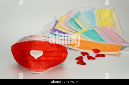 medical mask with a heart. Celebrating Valentine's Day during a pandemic. gratitude to doctors for their work Stock Photo