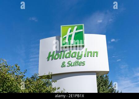 Mississauga, Ontario, Canada- September 19, 2020: Close up of Holiday Inn sign with blue sky in background is seen in Mississauga, Ontario, Canada. Stock Photo
