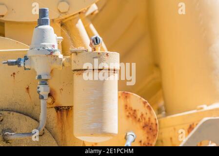 A horizontal anonymous close up image of rusting disused yellow painted, heavy machinery Stock Photo