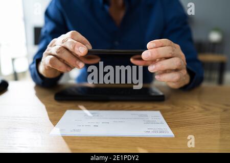Remote Check Deposit Taking Photo With Mobile Phone Stock Photo