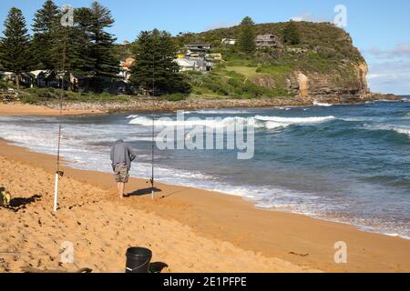 Men fishing on Avalon Beach in the late afternoon sunshine,Sydney,Australia Stock Photo