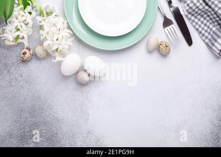 Light Easter composition. Green mint plate, easter eggs, pink and white hyacinth on stone background. Easter concept - Image Stock Photo