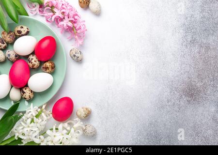 Green mint plate with easter eggs and hyacinths on stone background. Easter concept. Flat lay - Image Stock Photo