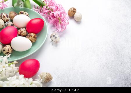 Green mint plate with easter eggs and hyacinths on stone background. Easter concept - Image Stock Photo