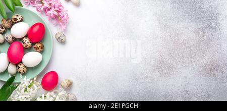 Easter composition. Green mint plate, easter eggs, pink and white hyacinth on stone background. Horizontal banner. Copy space for text - Image Stock Photo