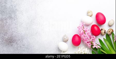 Spring composition. Easter eggs, pink and pink hyacinth on stone background. Horizontal banner. Copy space for text - Image Stock Photo