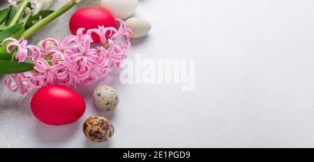 Spring composition. Easter eggs, pink and pink hyacinth on stone background. Horizontal banner. Copy space for text - Image Stock Photo