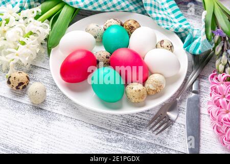 Easter eggs in white plate on wooden background. Easter concept - Image Stock Photo