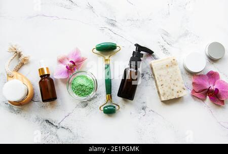 Zero waste bathroom accessories and jade roller on a marble background. Flat lay Stock Photo