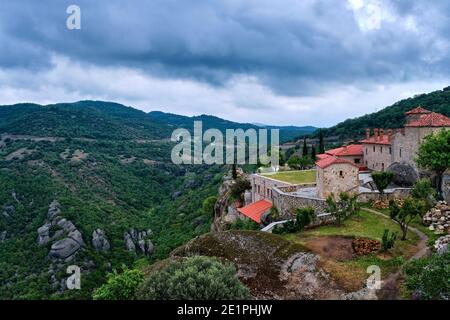 View of clifftop monastery buildings and terrace of Holy Trinity or Agia Triada on rocks of Meteora hills, Greece, UNESCO World Heritage Stock Photo