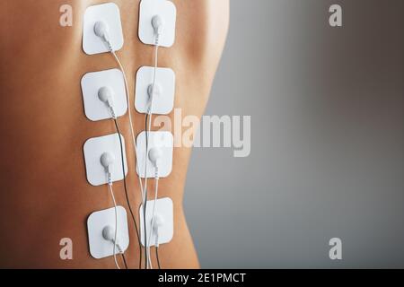 Electrode Stimulating massage of the spine at home. Medical procedure for muscle tone and beauty Soft contrast Stock Photo