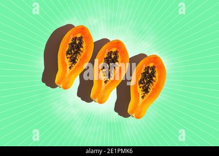 Three slices of papaya  on green background. Top view. Stock Photo