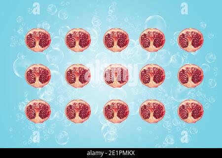 Symmetrical composition of pomegranate slices on blue background. Top view. Stock Photo