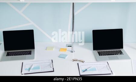 laptops and financial documents on the office Desk. Stock Photo
