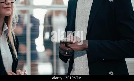 business man talking to his colleagues standing in the office Stock Photo