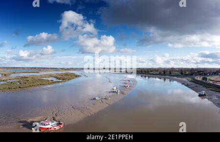 aerial panoramic view of the river chelmer looking over maldon mudflats and boat stuck in the mud Stock Photo