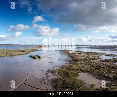 aerial panoramic view of the river chelmer looking over maldon mudflats and boat stuck in the mud Stock Photo