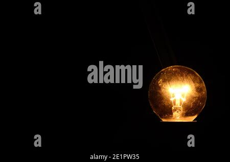 round light bulb shines in the darkness Stock Photo