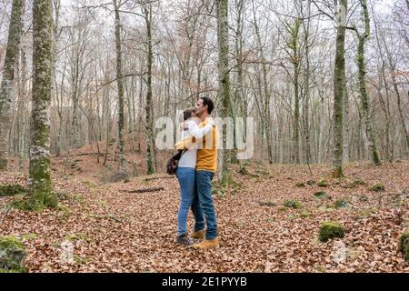 Beautiful young couple hugging in forest.Romantic , love and friendship lifestyle.Travel concept.