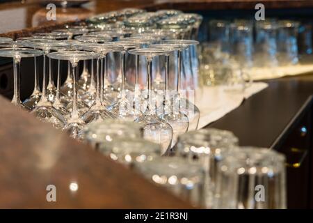 Wine glasses stacked together on the counter of a bar Stock Photo