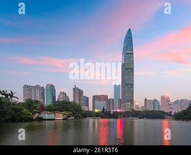 Shenzhen, China city park and skyline and at twilight. Stock Photo