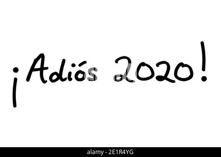 Adios 2020! - meaning Goodbye 2020! in the Spanish language - handwritten on a white background. Stock Photo