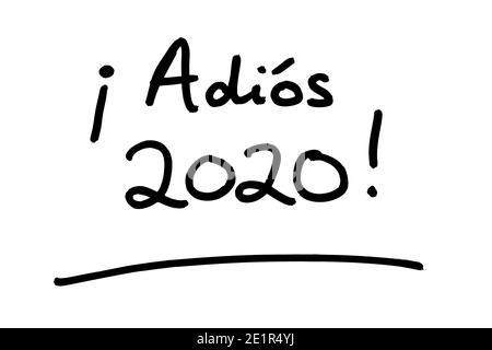 Adios 2020! - meaning Goodbye 2020! in the Spanish language - handwritten on a white background. Stock Photo