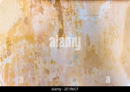 Vintage grunge texture of old weathered dirty wall. Painted cracked walls, textured in cracks and drips of paint. Unique scenic unusual background. Cement wall with stain marks. A texture of an old orange wall. High quality photo Stock Photo